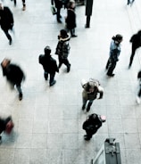 people walking on grey concrete floor during daytime