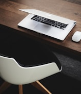 Apple MacBook beside computer mouse on table